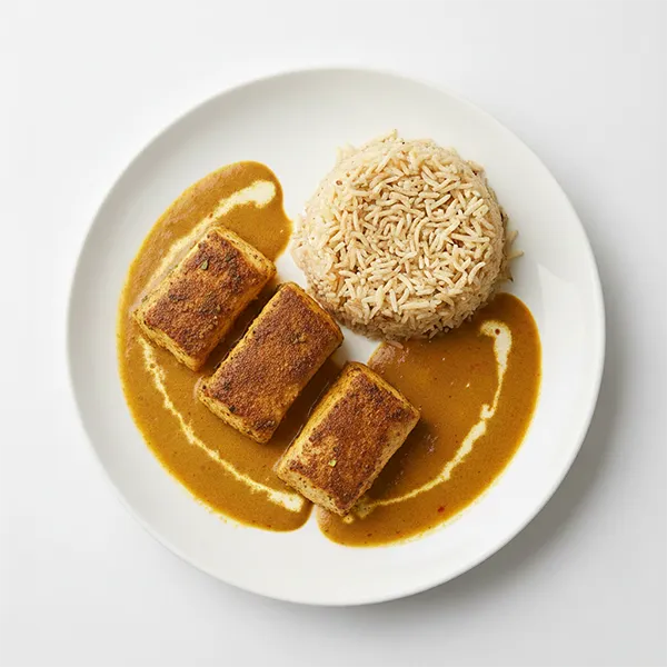 Masala baked fish with aromatic brown rice and creamy curry sauce